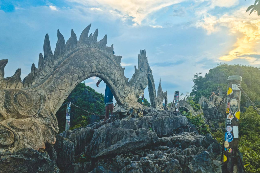 Visitors are greeted by the striking sight of a winding stone dragon sculpture that gracefully stretches along the mountain ridge